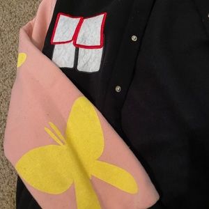 Black, pink jacket with yellow butterflies